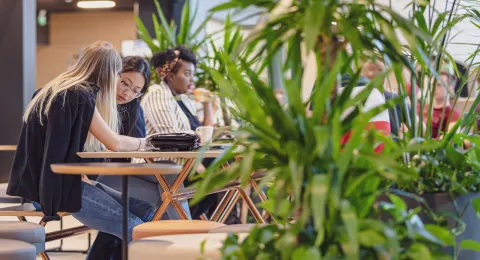 International student reading in Street Cafe at LUT University campus