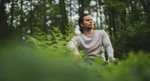 LUT University student sitting in the woods