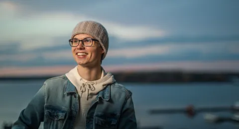 LUT University student smiling at the lakeside