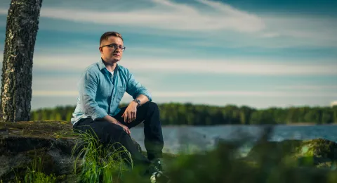 LUT University master&#039;s student sitting at the shore