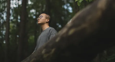 LUT University student in the woods looking at the sky