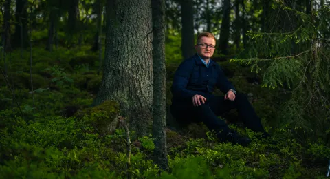 LUT University student sitting in the woods