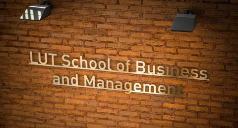 LUT School of Business and Management logo on a brick wall