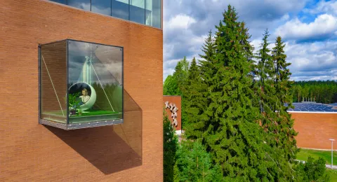 Student in glass balcony at LUT University campus