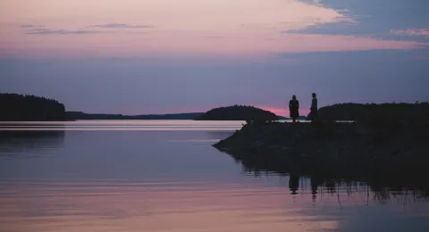 Students in sunset dock at lake Saimaa in LUT University