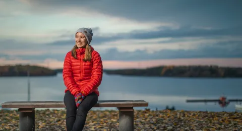 LUT University student sitting on a bench autumn scene