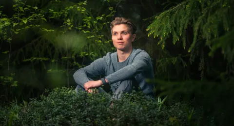 LUT University student sitting in the woods