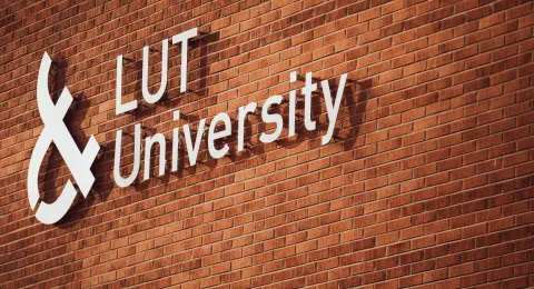 LUT University logo on a brick wall 