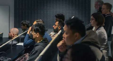 A diverse group of students listening to a lecture