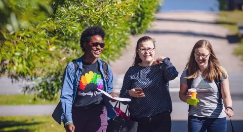 A diverse group of students walking on campus