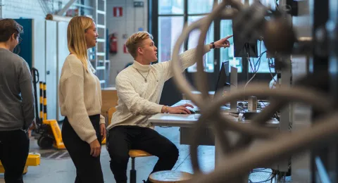 Students on campus in energy technology laboratories