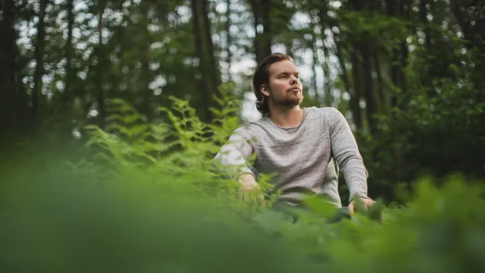 LUT University student sitting in the woods