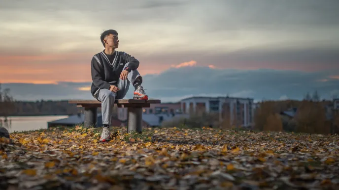 LUT University sitting on a bench in a fall scenery