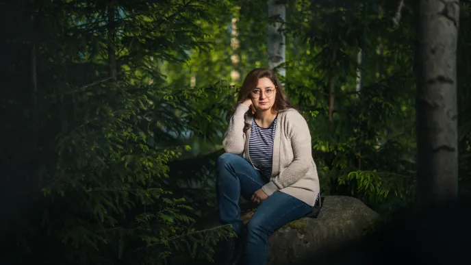 LUT University student sitting in the forest