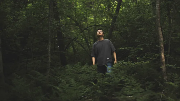 LUT University student in a forest watching the sky