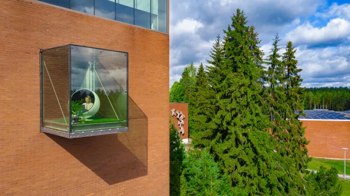 Student in glass balcony at LUT University campus