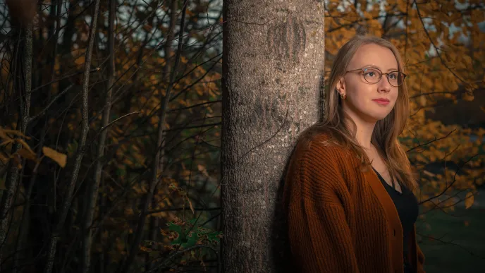 LUT University student in a forest at sunset