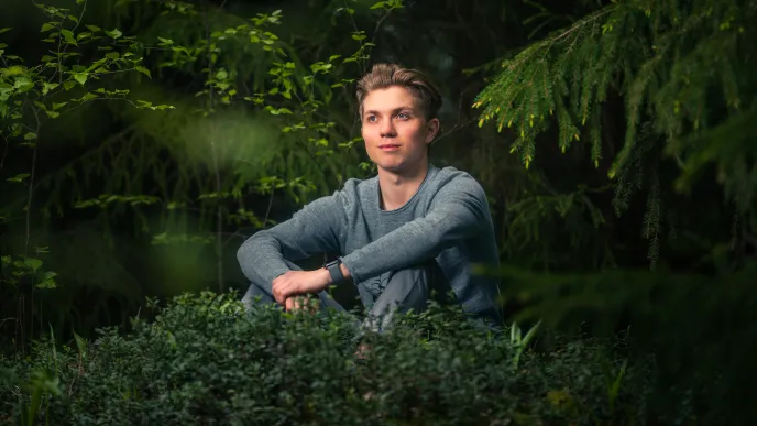 LUT University student sitting in the woods