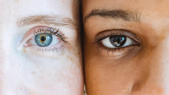 Light and dark skinned persons staring at a camera