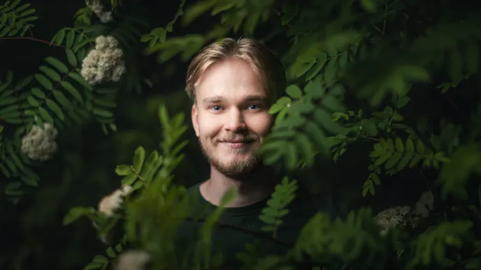 a man is smiling in the middle of the picture