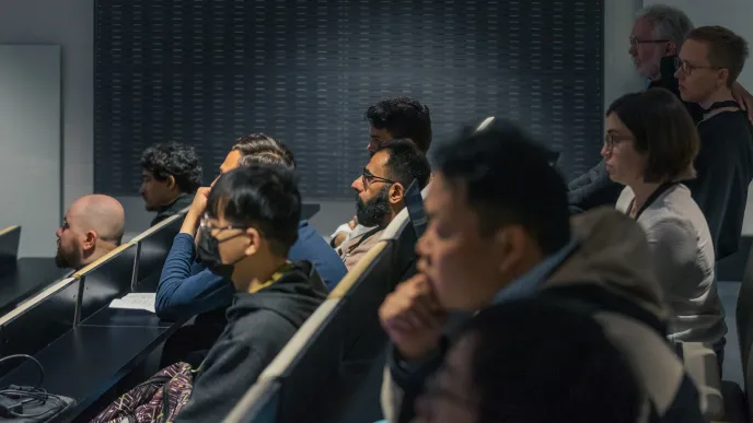 A diverse group of students listening to a lecture