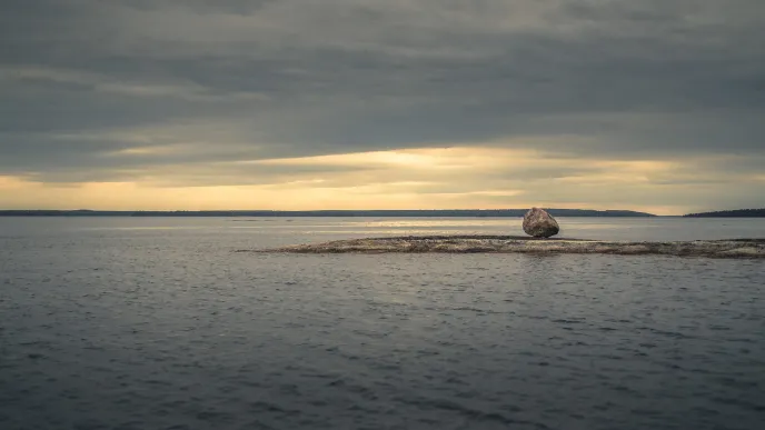 Lake landscape with a rock
