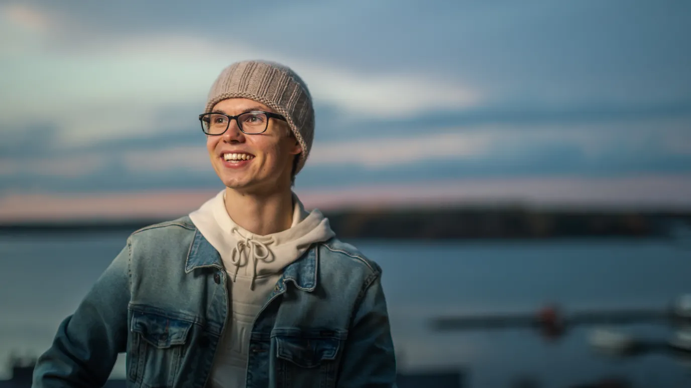 LUT University student smiling at the lakeside