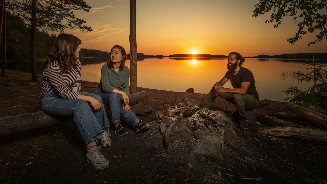 Group of LUT University students on a shore at sunset