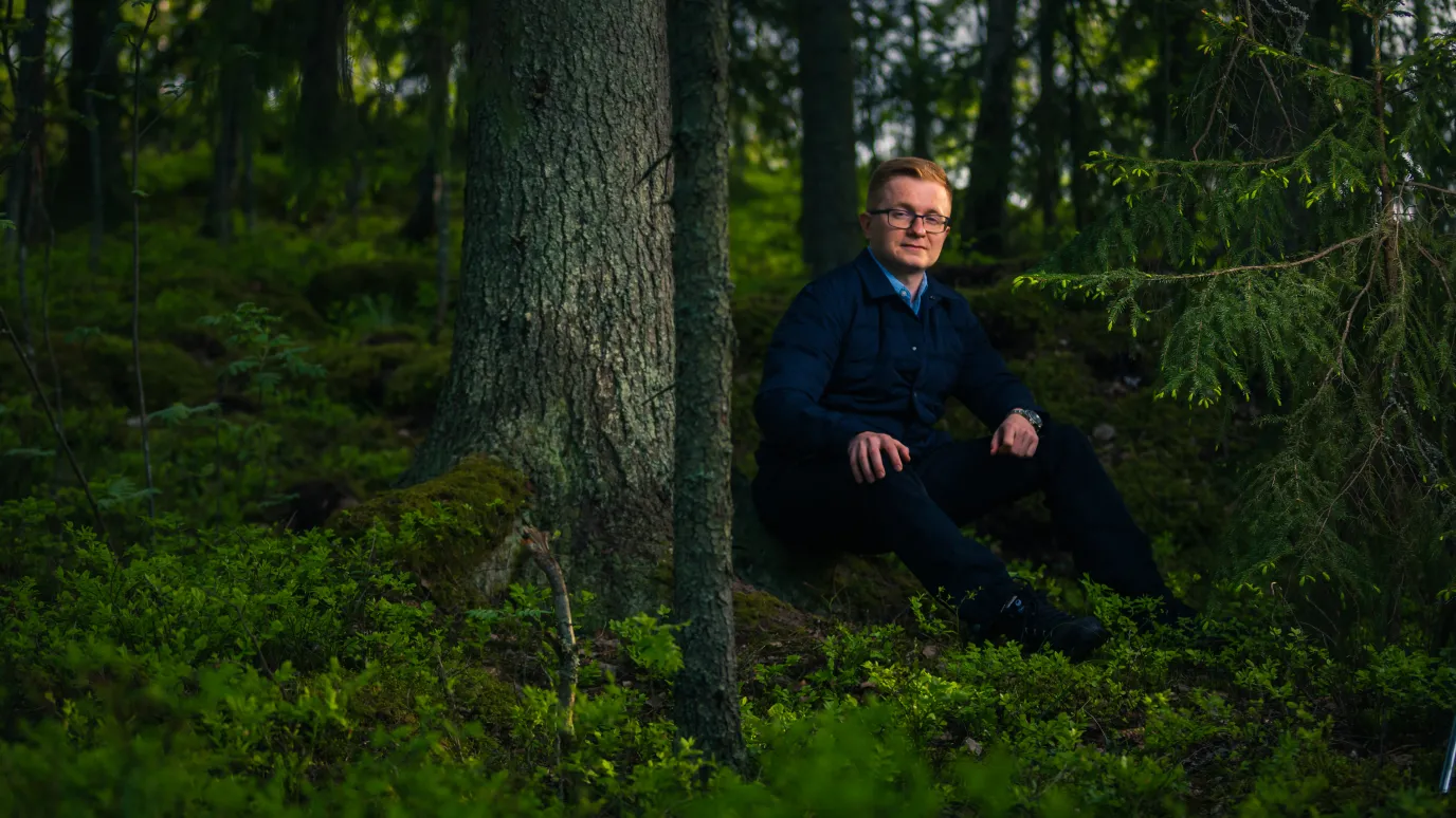 LUT University student sitting in the woods