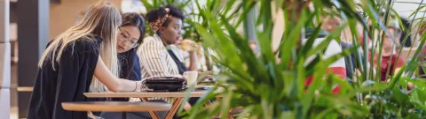 People sitting and talking at the campus lobby.